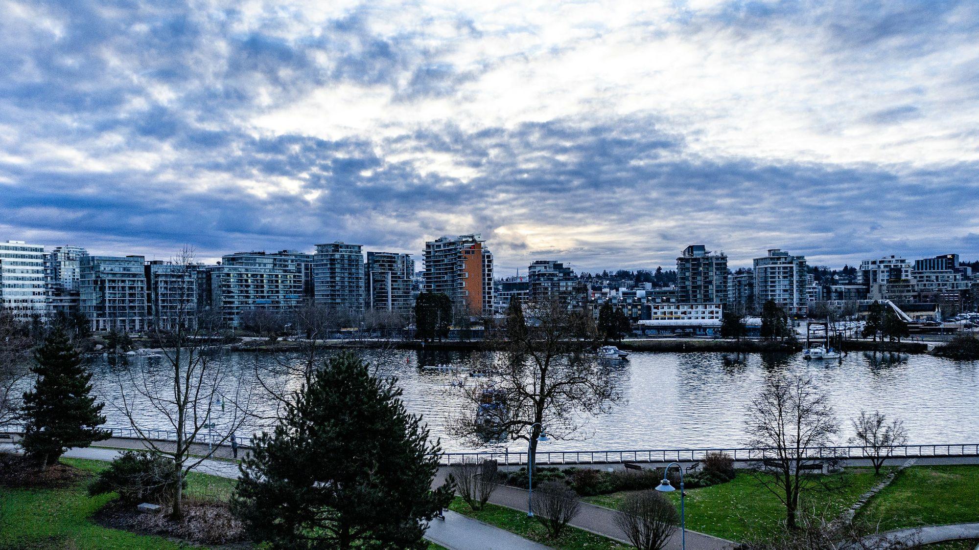 Olympic Village seen across False Creek from the north shore seawall, with the village's mid-rise buildings along the water