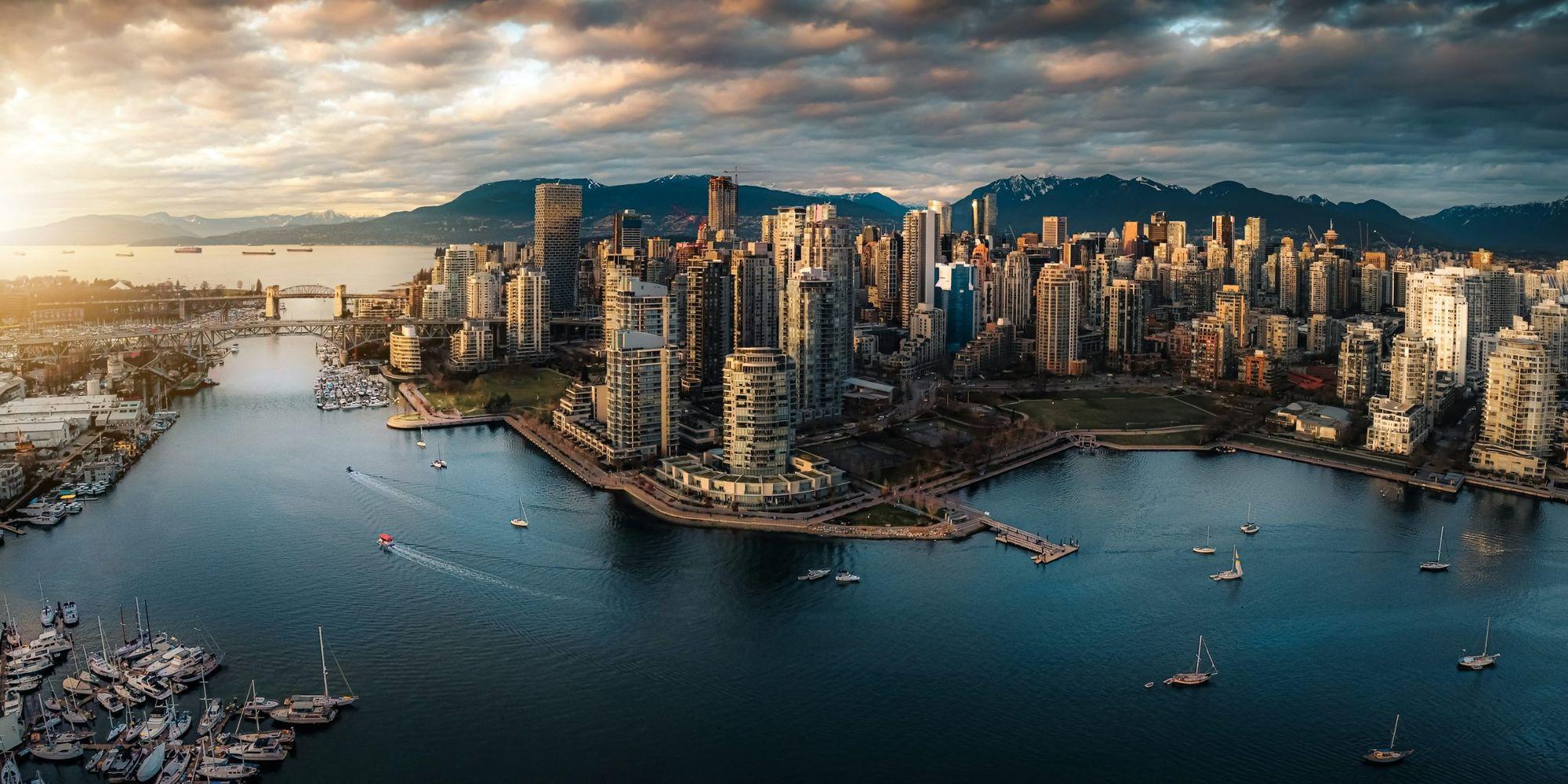 Aerial view of the Yaletown waterfront and David Lam Park on False Creek, with downtown Vancouver and the North Shore mountains behind